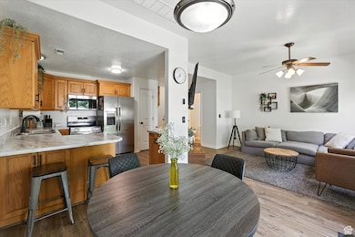 Dining area featuring light wood-style flooring and a ceiling fan