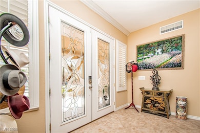 Entrance foyer with crown molding and baseboards