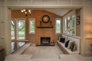 Floor to Ceiling Fireplace in a warm, step down hearth area with built in seating.
