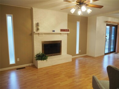 Family room, freshly painted, brick wood-burning f