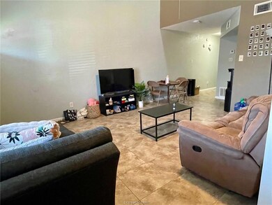 Living area featuring light tile patterned floors