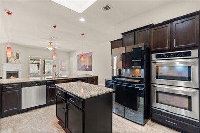 This kitchen is by far any chef’s dream! This spacious kitchen features high ceilings, dark stained wood cabinets, granite countertops, SS appliances, modern tile backsplash, recessed lighting with additional custom pendant lighting, extended counter space, granite kitchen island, space for breakfast bar, and a walk-in pantry all overlooking your huge family room.