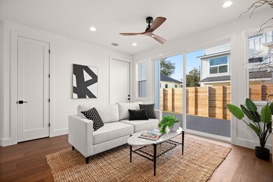 Living area featuring a ceiling fan, visible vent