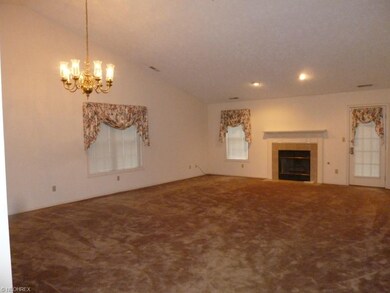 Vaulted great room with gas fireplace and door lea