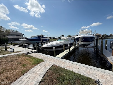 Dock featuring boat lift and a water view