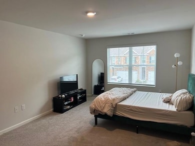 Carpeted bedroom with baseboards