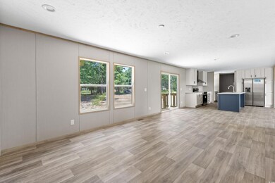 Unfurnished living room featuring sink and light h