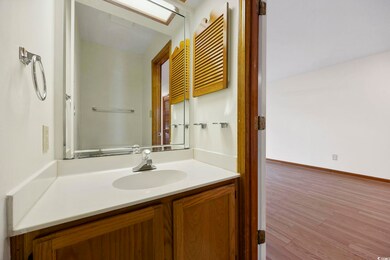 Bathroom featuring baseboards, wood finished floor