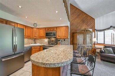 Updated kitchen with granite and matte stainless.