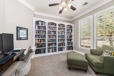 French doors open up to the office with custom built-in bookshelves and ability to control the amount of light with custom plantation shutters.