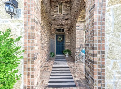 A long walkway is mesmerizing and brings us through elegant brick arches, all the way up to the gorgeous dark stained front door!