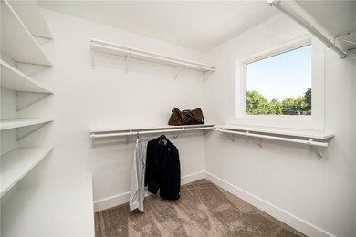 Primary's closet with custom shelving.  Most build