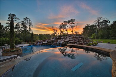 Giant hot tub overlooks the beauty accompanied by this picturesque rock waterfall that adds an element of splendor to the glorious grounds and property.