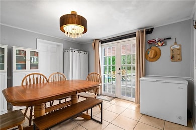 Dining space with beautiful french doors and  chan