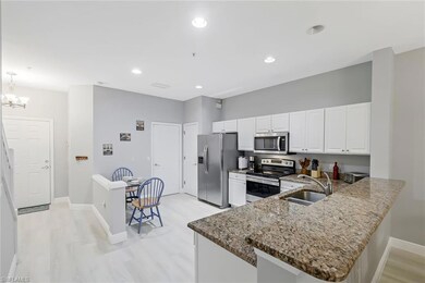 Kitchen with light wood-type flooring, appliances 