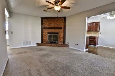 Unfurnished living room with dark carpet, a firepl