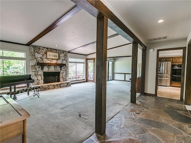 View from hallway into the den, dining room and ki