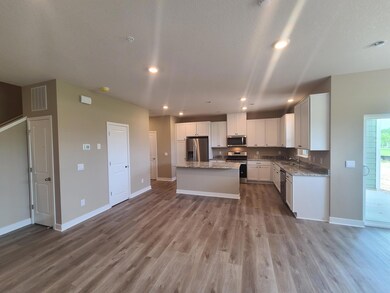 Spacious Kitchen including stainless steel refrigerator, oven/range, microwave, and dishwasher.  Photo is of actual home.