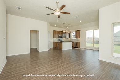 Unfurnished living room with dark wood-type flooring, ceiling fan, and recessed lighting