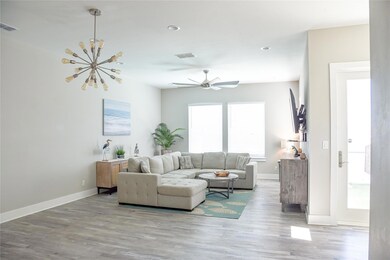 Living area featuring visible vents, baseboards, a