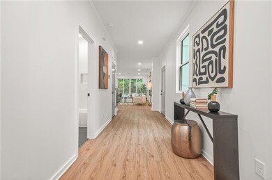 Hall featuring LVP flooring, baseboards, recessed lighting