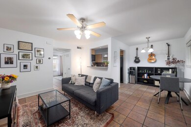 Living area featuring ceiling fan and baseboards