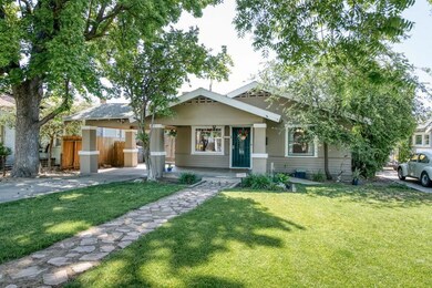 Grassy lawn, shade trees, stone walk way, and a co