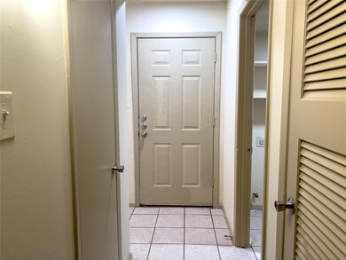 Doorway to outside featuring light tile patterned