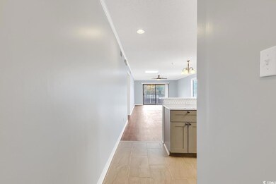 Hallway featuring a chandelier, recessed lighting, and crown molding