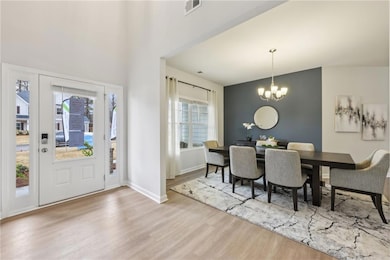 Dining space with wood finished floors, plenty of 