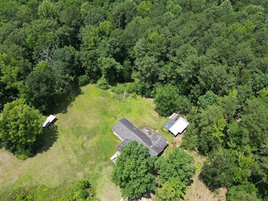 View of property location featuring a forest