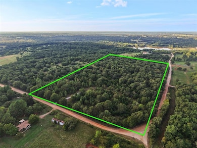 Aerial view of property and surrounding area with property boundaries highlighted and a heavily wooded area