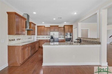Gourmet kitchen with range hood, granite, added ba