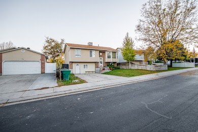 Bi-level home with an outdoor structure and driveway