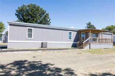 Rear view of house featuring a porch and central a