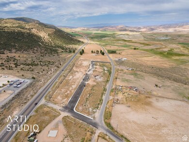 Aerial view of property and surrounding area with mountains and rural landscape