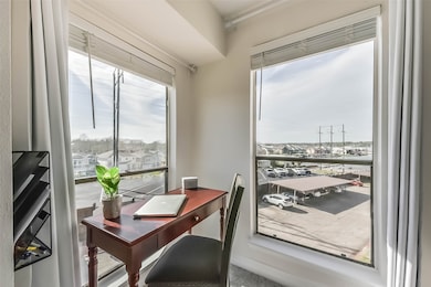 This bright primary bedroom with large windows pro