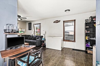 Office space with healthy amount of natural light, cooling unit, and a ceiling fan