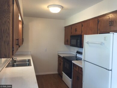 Kitchen has newer flooring, window above the kitch