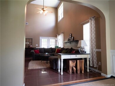 Arched entry into the 2-story living room.