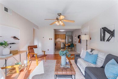 Living area with light wood-type flooring and ceiling fan