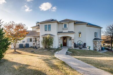 Stucco and Stone exterior and beautiful seasonal color w Native Texas landscaping.