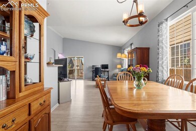 Dining area with vaulted ceilings and newer light fixture