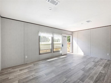 Empty room featuring wood finished floors