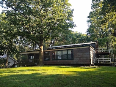 Rear view of house featuring a wooden deck and a l