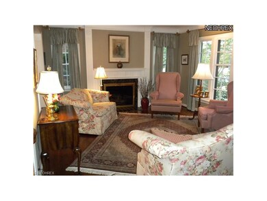 Formal living room features hardwood floors,  buil