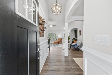 Entryway featuring a towering ceiling, ceiling fan