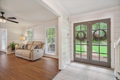 Entryway featuring ornamental molding, plenty of n