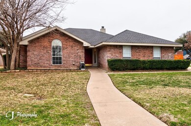 Ranch-style home featuring a front yard