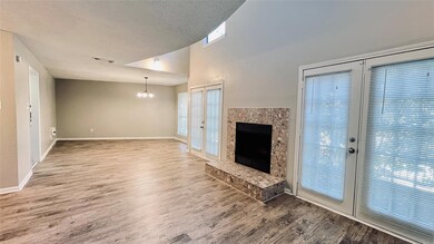 Unfurnished living room featuring a chandelier, w
